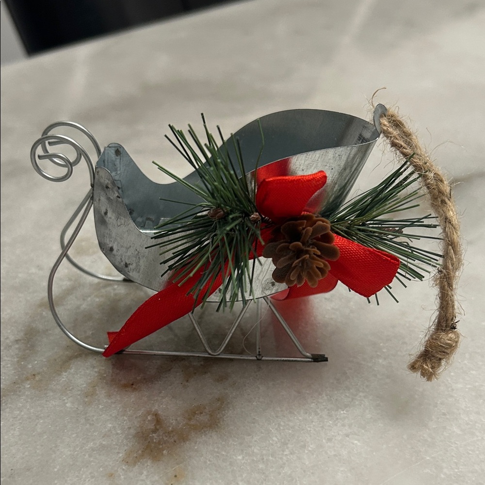 Festive Metal Sleigh Ornament with Red Bow